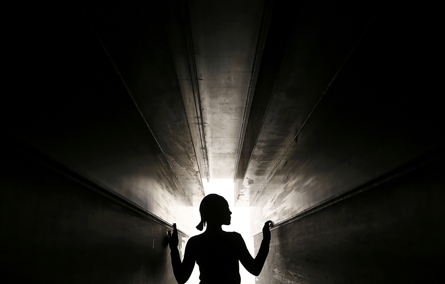 A member of the gallery poses for a photograph inside a piece called "Passage", by artist Antony Gormley, which forms part of an exhibition entitled "Fit", at the White Cube gallery in London, Britain September 29, 2016. REUTERS/Peter Nicholls